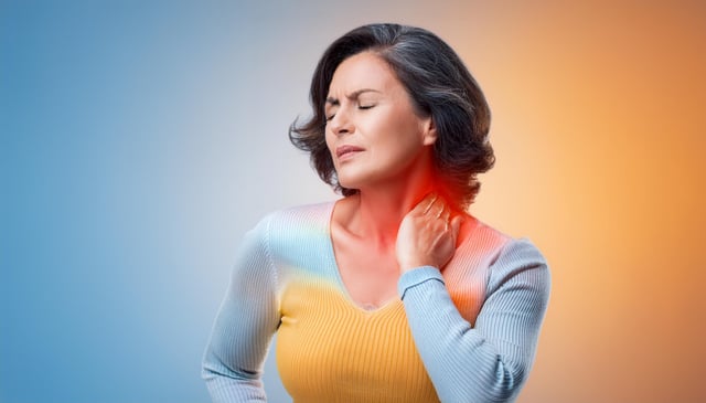 A woman winces in pain, clutching her neck with one hand. She wears a light blue and yellow sweater, with redness highlighting the painful area on her neck.